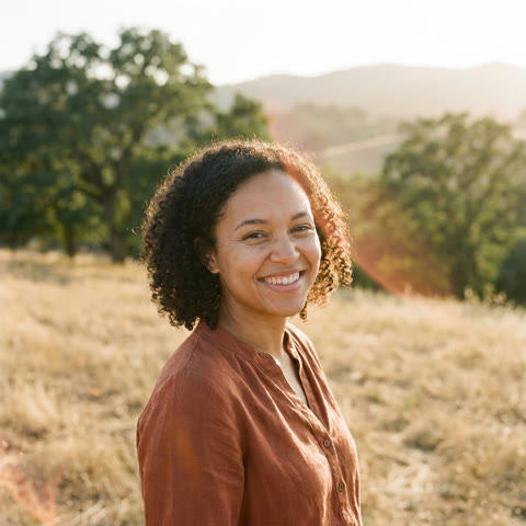 Dr. Maya Ellison, outdoors at golden hour